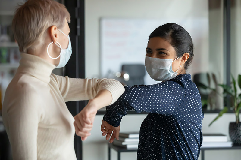 female colleagues wearing protective masks