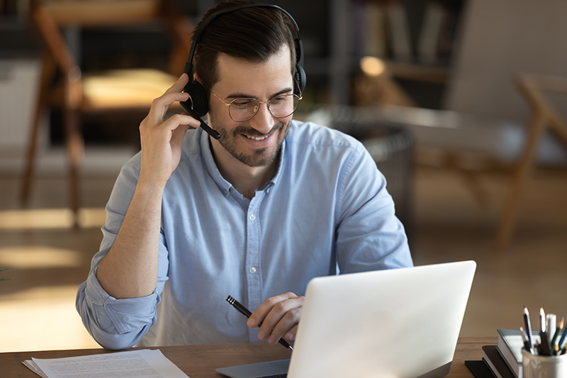 smiling millennial man with headset