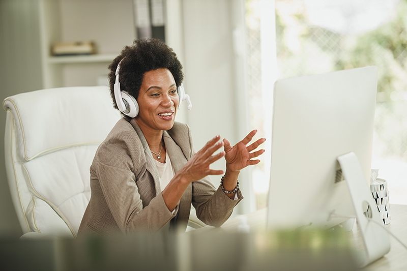 businesswoman with headphones having video call